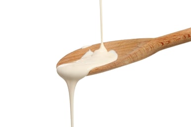 creamy salad dressing being poured